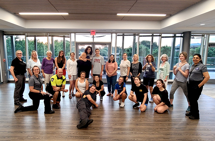 A group of women and teens at the Women & Teen Safety Class with JCPD officers.